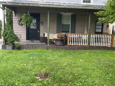a house with a porch with a fence at Amish Country Stay w/ Buggy Ride in Gap