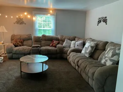 a living room with a large couch and a table at Amish Country Stay w/ Buggy Ride in Gap