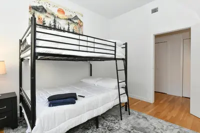 a bedroom with two bunk beds in a room at Luxury 3 Bedroom Retreat in Downtown Manhattan in New York