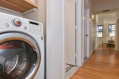 a washer and dryer in a hallway of a house at Luxury 3 Bedroom Retreat in Downtown Manhattan in New York
