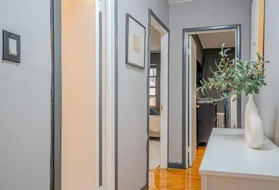 a hallway leading into a living room with a white counter at Chic 3Bd NoMad Manhattan in New York