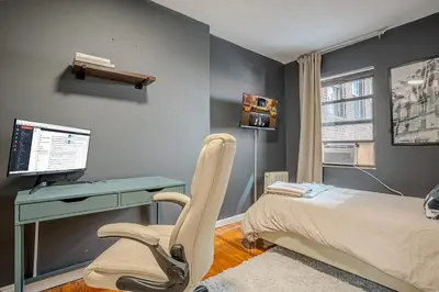 a bedroom with a desk and a bed with a computer at Chic 3Bd NoMad Manhattan in New York