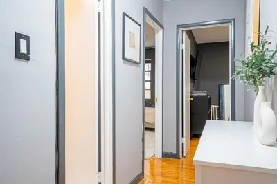 a hallway with a door leading into a living room at Chic 3Bd NoMad Manhattan in New York