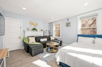 a living room with a bed and a couch at Cozy Apt in Center City! in Philadelphia