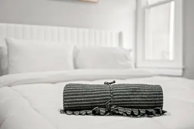 a black and white photo of a purse on a bed at Cozy Apt in Center City! in Philadelphia