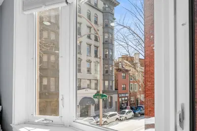 a window with a view of a street and buildings at Cozy Apt in Center City! in Philadelphia