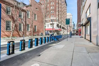 a row of blue parking meters on a city street at Cozy Apt in Center City! in Philadelphia