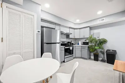a kitchen with a table and chairs and a refrigerator at Cozy Apt in Center City! in Philadelphia