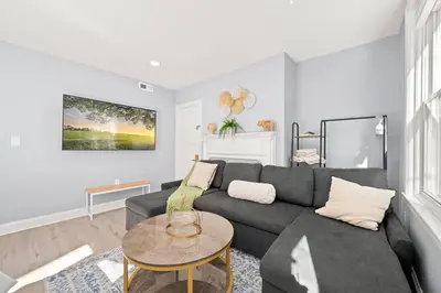 a living room with a couch and a table at Cozy Apt in Center City! in Philadelphia