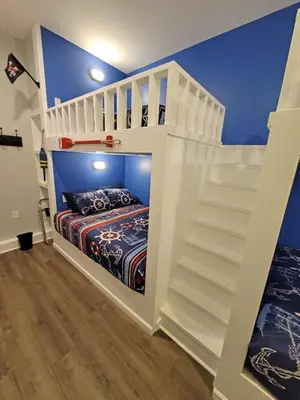 a white bunk bed in a room with a staircase at 5 BR Coyote Cliff Corner HUGE Luxury w/Hot Tub and Linens in Albrightsville