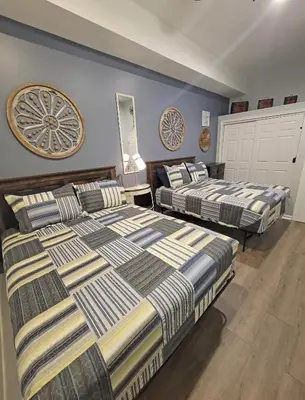 a bedroom with two beds and a wall at 5 BR Coyote Cliff Corner HUGE Luxury w/Hot Tub and Linens in Albrightsville