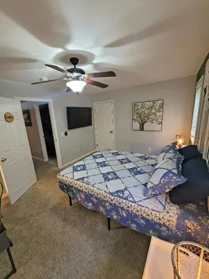 a bedroom with a bed and a ceiling fan at 5 BR Coyote Cliff Corner HUGE Luxury w/Hot Tub and Linens in Albrightsville
