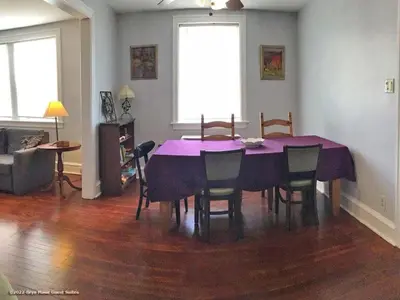 a dining room with a purple table and chairs at Bryn Mawr Guest Suites in Bryn Mawr