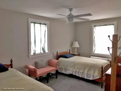 a bedroom with two beds and a ceiling fan at Bryn Mawr Guest Suites in Bryn Mawr