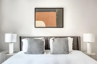 a bedroom with a white bed with two lamps at Brooklyn Heights 2br w elevator wd NYC-1066 in Brooklyn