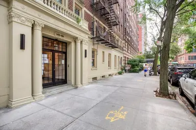 a person walking down a sidewalk next to a building at Brooklyn Heights 2br w elevator wd NYC-1066 in Brooklyn