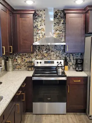 a kitchen with wooden cabinets and a stove top oven at Timber Top Terrace - Huge Luxury 6 BR - Sleeps 16 Linens and Towels Included in Albrightsville
