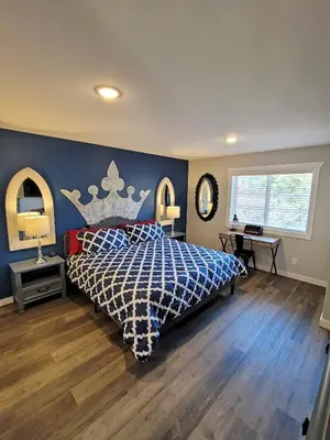 a bedroom with a bed with a blue wall at Timber Top Terrace - Huge Luxury 6 BR - Sleeps 16 Linens and Towels Included in Albrightsville