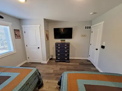 a bedroom with two beds and a tv on the wall at Timber Top Terrace - Huge Luxury 6 BR - Sleeps 16 Linens and Towels Included in Albrightsville