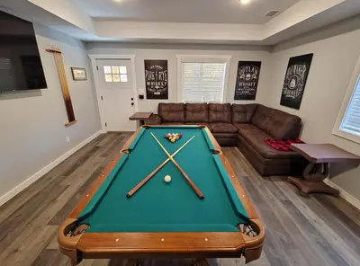 a living room with a pool table and a couch at Timber Top Terrace - Huge Luxury 6 BR - Sleeps 16 Linens and Towels Included in Albrightsville