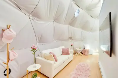 a living room with a couch in a tent at Unique Escapes - Rosé All Day Geodome in Monticello
