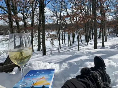 a glass of wine in the snow next to a glass of wine at Lakefront, Hot Tub, Heated Pool, Beach, Free Boats in Bushkill