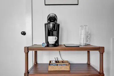 a coffee maker sitting on a wooden table at Lakefront, Hot Tub, Heated Pool, Beach, Free Boats in Bushkill
