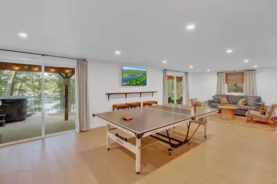 a living room with a ping pong table in it at Lakefront, Game Rm, Arcade, Hot Tub, Pool, Pets in Bushkill