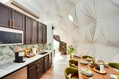 a room with a table and chairs and a large wall at Unique Escapes - Nature Lovers Geodome in Monticello