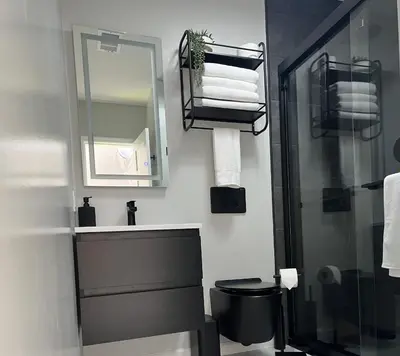 a bathroom with a sink and a toilet and a mirror at Unique Escapes - Modern Luxury Geodome in Monticello