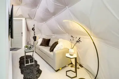 a living room with a white couch in a tent at Unique Escapes - Modern Luxury Geodome in Monticello