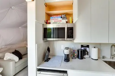 a small kitchen with a counter with a microwave at Unique Escapes - Modern Luxury Geodome in Monticello