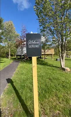 a sign in the grass in a park at Unique Escapes - Modern Luxury Geodome in Monticello