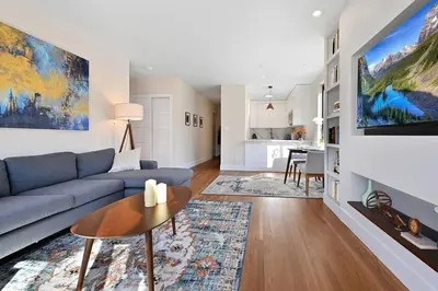 a living room with a blue couch and a table at Modern one bedroom with private balcony in New York