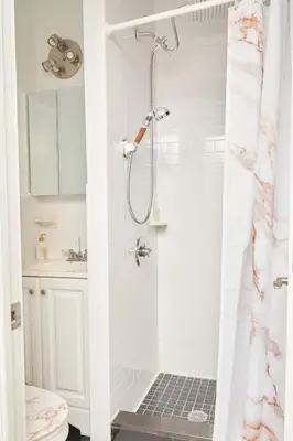 a bathroom with a shower with a sink and a toilet at Private Loft in Hells Kitchen near Times Square in New York