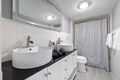 a white bathroom with a sink and a toilet at Modern Lodge on 6 acres - 15 mins to Camelback in Cresco