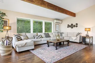 a living room with two couches and a table at Modern Lodge on 6 acres - 15 mins to Camelback in Cresco