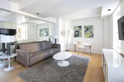 a living room with a couch and a table at PlanURstay - Spacious Midtown West Fully-Serviced - 1BR & 1BTH in New York