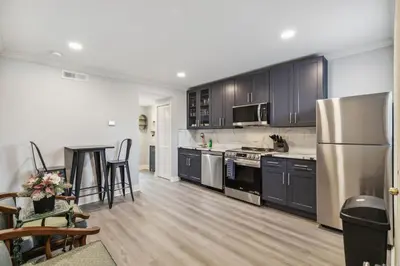 a kitchen with a stainless steel refrigerator and cabinets at AF Stays - Philadelphia Callowhill in Philadelphia