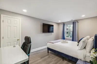a bedroom with a bed and a table and a window at AF Stays - Philadelphia Callowhill in Philadelphia