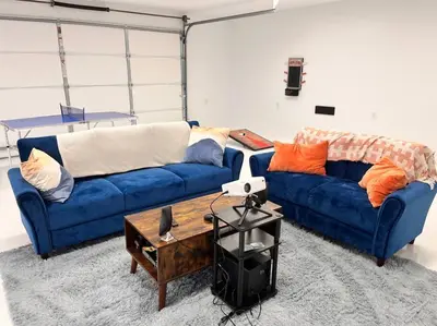 a living room with two blue couches and a coffee table at Luxury-Cabin Mount View *Gym*Game Room *Fire Place in Lehighton