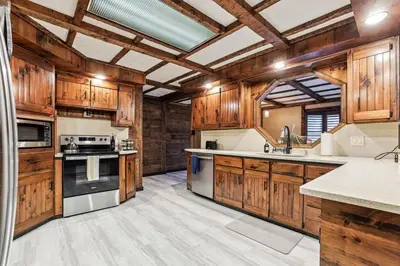 a large kitchen with wooden cabinets and appliances at Luxury-Cabin Mount View *Gym*Game Room *Fire Place in Lehighton