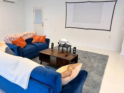 a living room with a blue couch and a table at Luxury-Cabin Mount View *Gym*Game Room *Fire Place in Lehighton