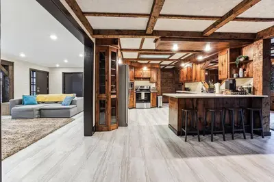 an open kitchen and living room with wooden ceilings at Luxury-Cabin Mount View *Gym*Game Room *Fire Place in Lehighton