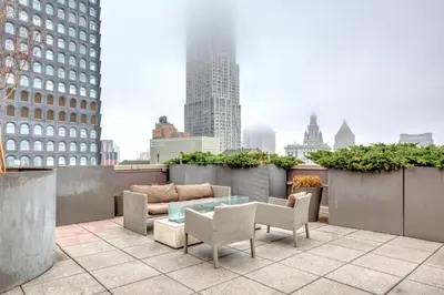 a patio with a table and chairs on a building at FiDi 2br w wd doorman elevator roof NYC-772 in New York