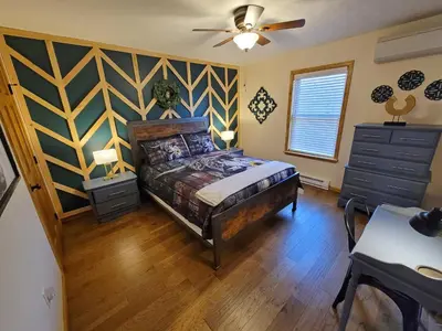 a bedroom with a bed and a ceiling fan at Swept Away Chalet - Luxurious NEW 6 BR Home Sleeps 16 Hot Tub Linens and Towels in Albrightsville