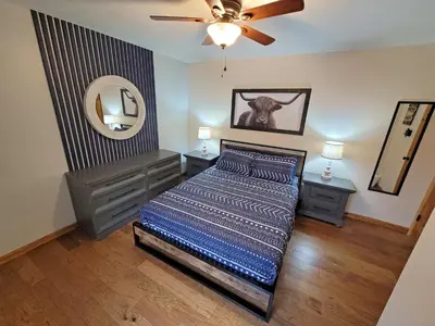 a bedroom with a bed and a ceiling fan at Swept Away Chalet - Luxurious NEW 6 BR Home Sleeps 16 Hot Tub Linens and Towels in Albrightsville