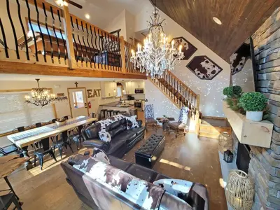 a large living room with couches and a dining room at Swept Away Chalet - Luxurious NEW 6 BR Home Sleeps 16 Hot Tub Linens and Towels in Albrightsville