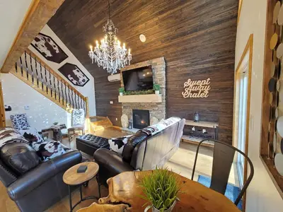 a living room with a couch and a fireplace at Swept Away Chalet - Luxurious NEW 6 BR Home Sleeps 16 Hot Tub Linens and Towels in Albrightsville