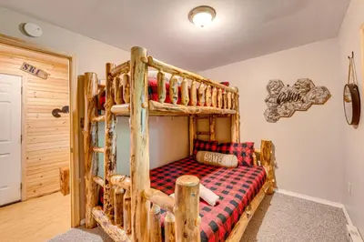 a bedroom with a bunk bed in a cabin at Game Room, Hot Tub! Cabin 9 Mi to Big Boulder Mtn in Albrightsville